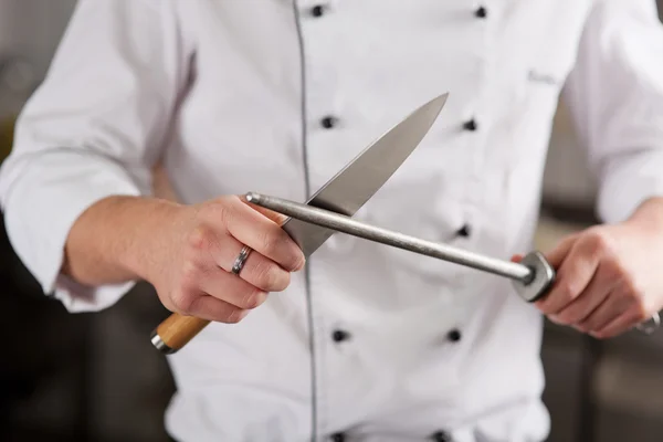 a chef sharpening a knife