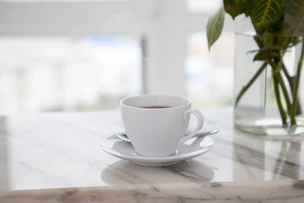 a cup of coffee on top of a quartz countertop