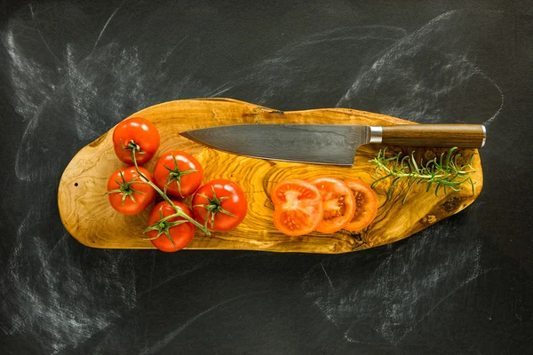 a damascus knife on top of a cutting board