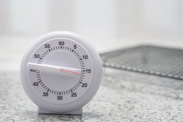 wind up kitchen timer on top of marble countertop