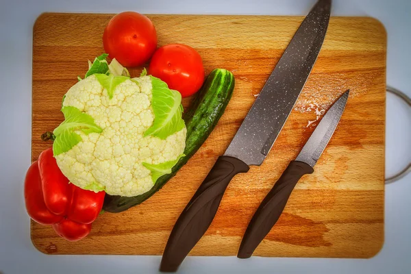 ceramic knives on top of a cutting board